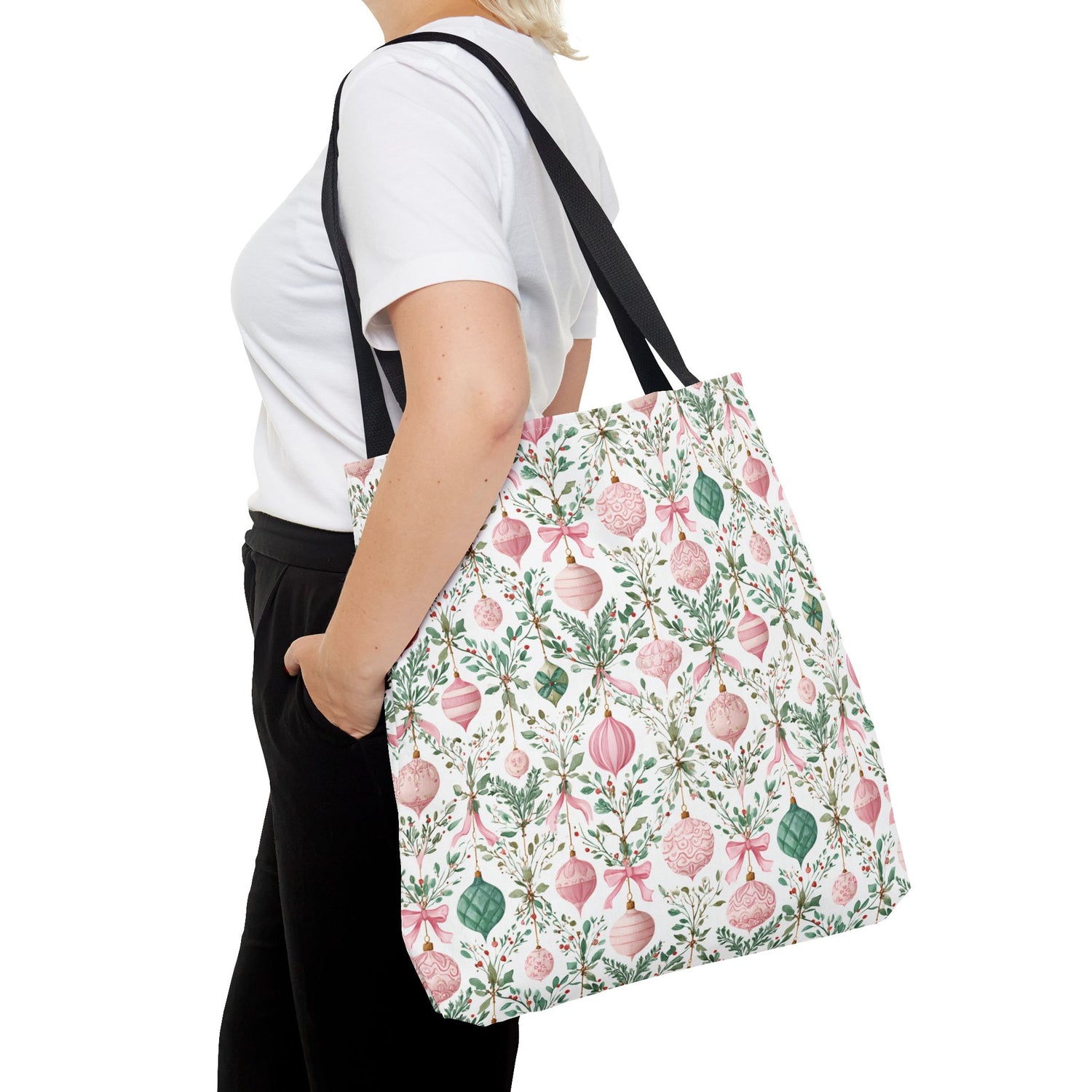 Person wearing a floral tote bag on a white background