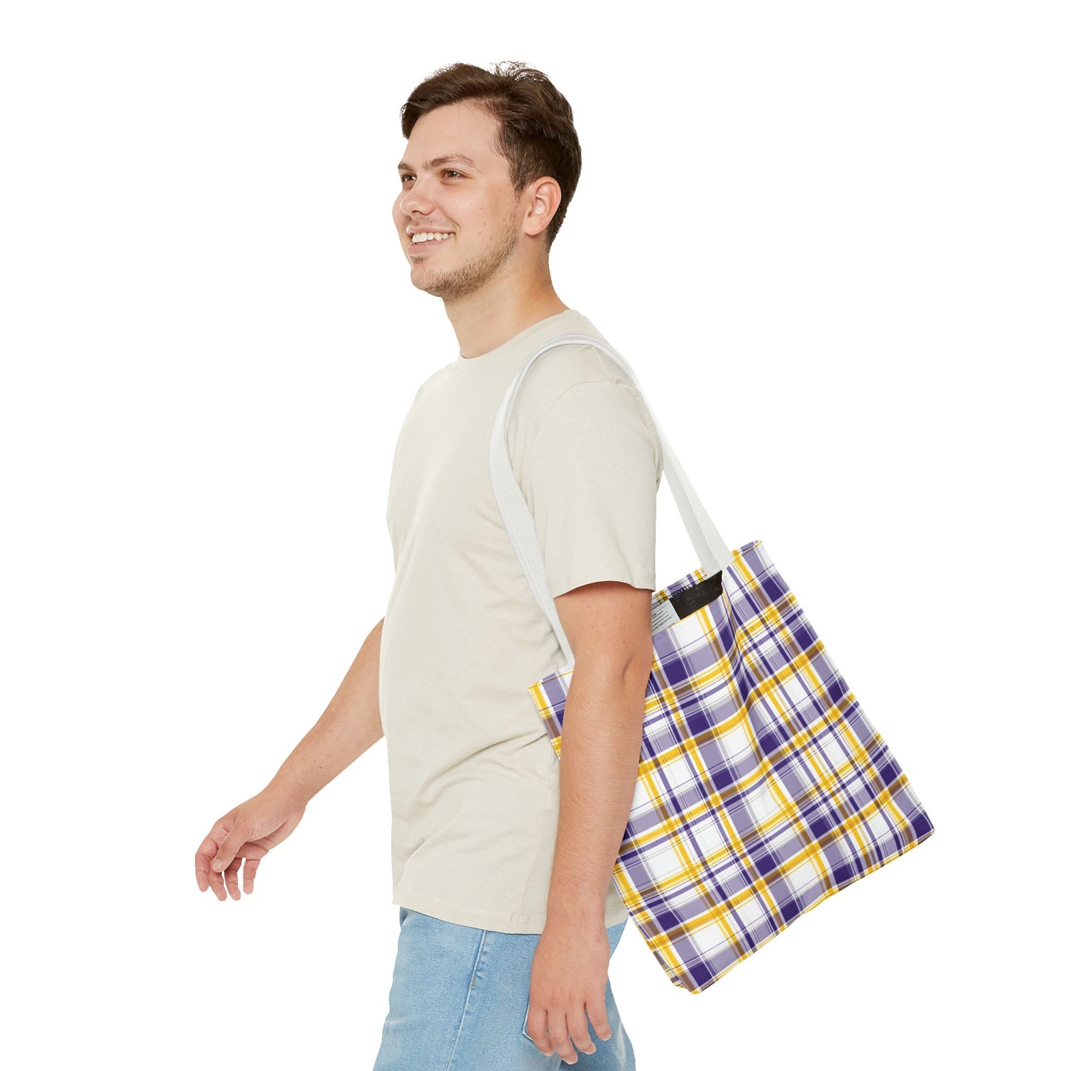 Man carrying a plaid bag on a white background