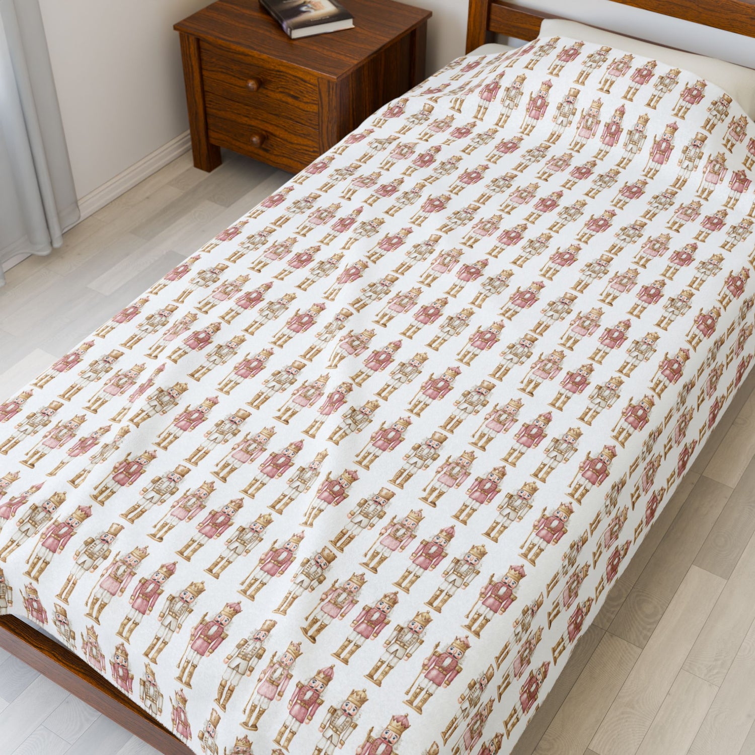 Bed with teddy bear patterned bedspread in a bedroom setting