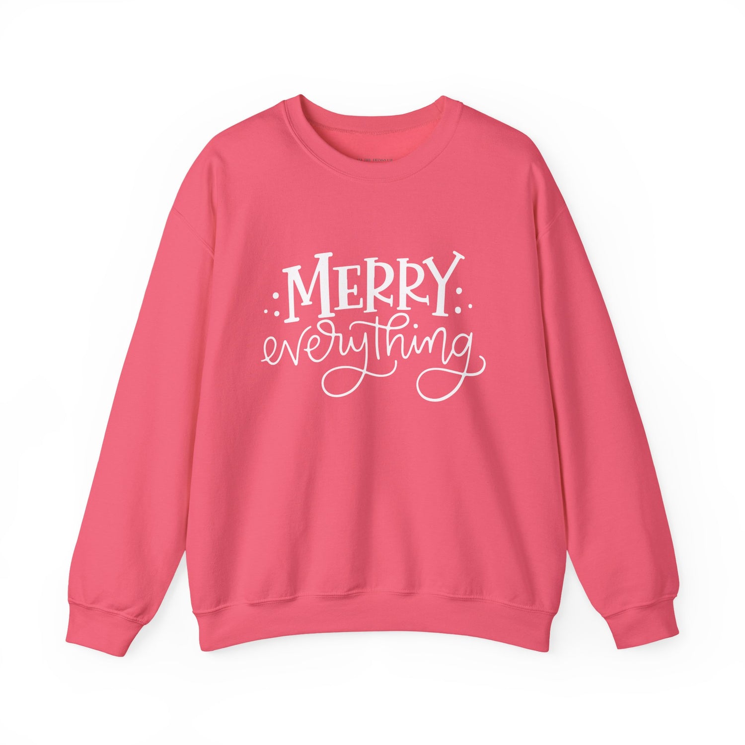 Pink sweatshirt with 'Merry Everything' text on a white background