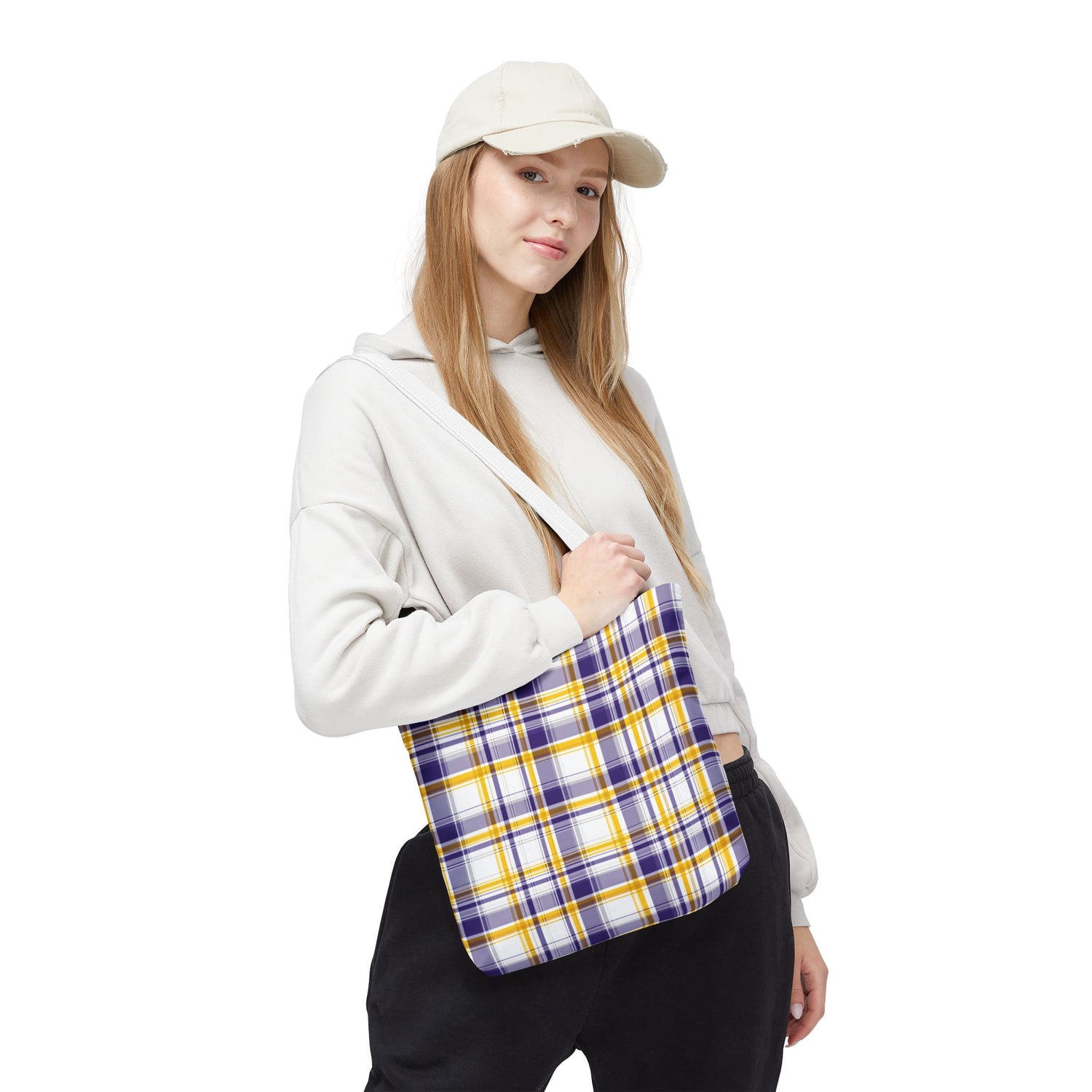 Person holding a plaid bag on a white background
