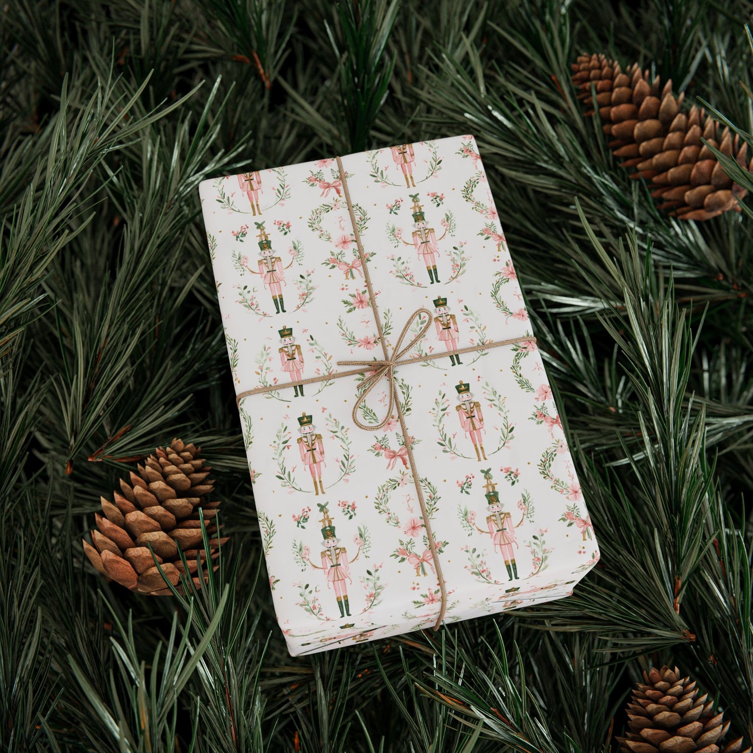 Gift wrapped in festive paper with nutcrackers on a bed of pine needles and pinecones.