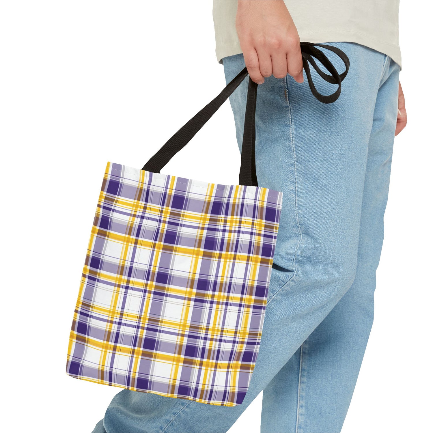 Person holding a plaid bag with purple, yellow, and white pattern.