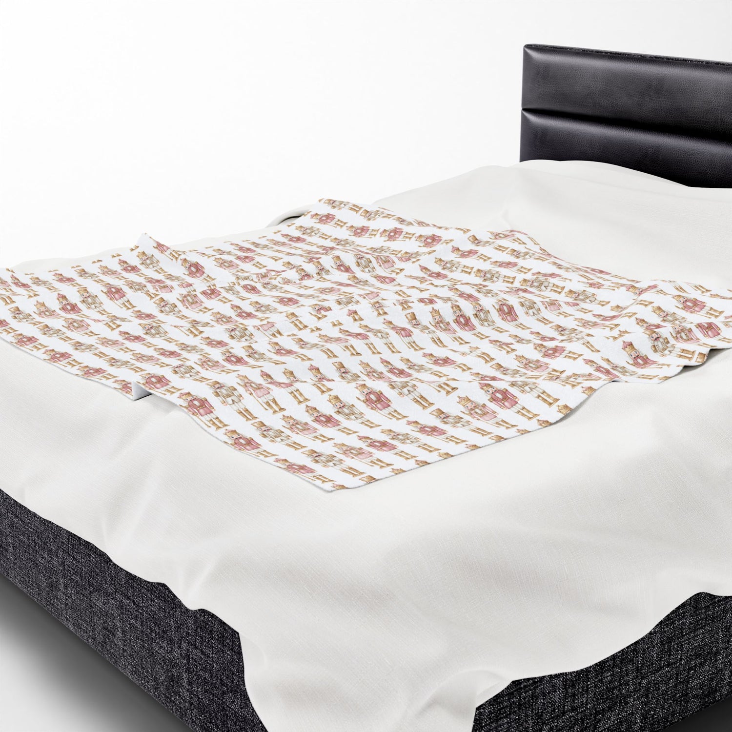 Bed with a floral-patterned comforter on a white background