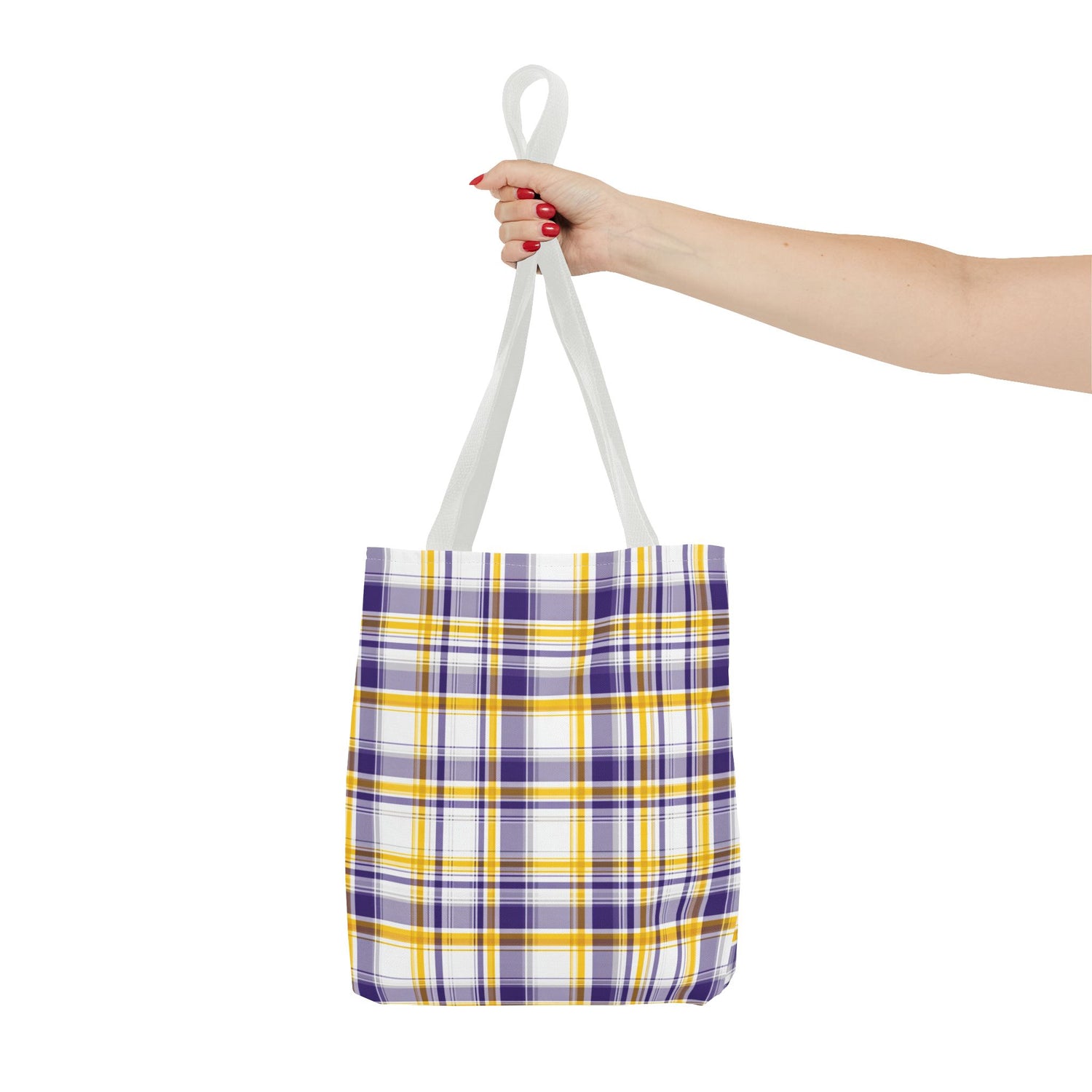 Tote bag with purple and yellow plaid pattern held by a hand on a white background