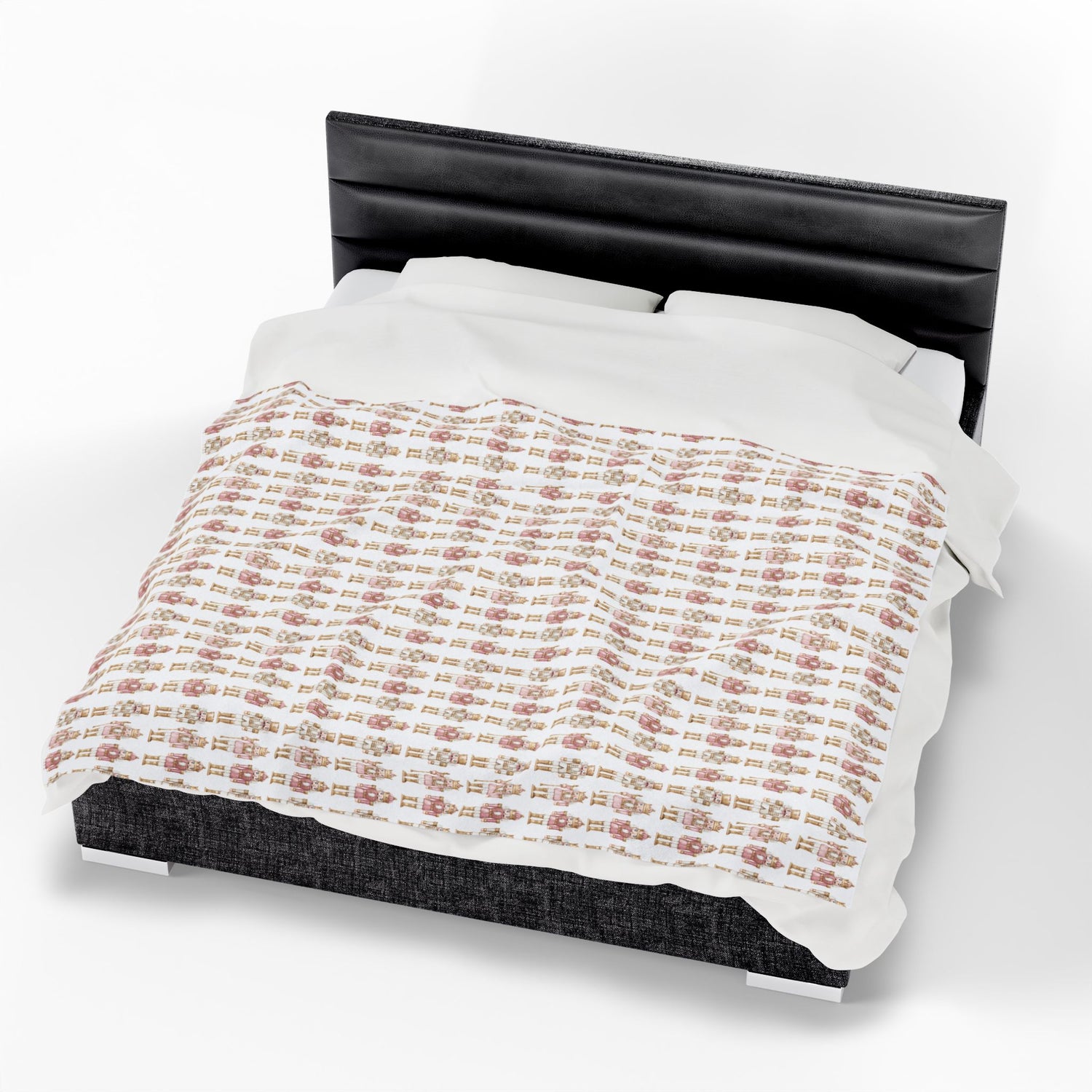 Bed with a patterned comforter and black headboard on a white background