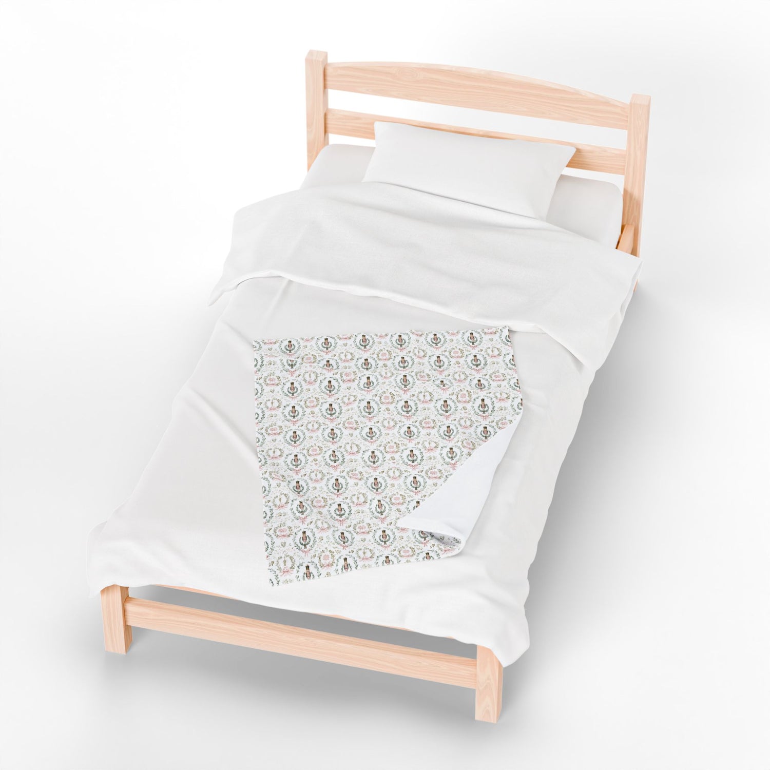 White duvet with a patterned corner on a wooden bed frame against a white background