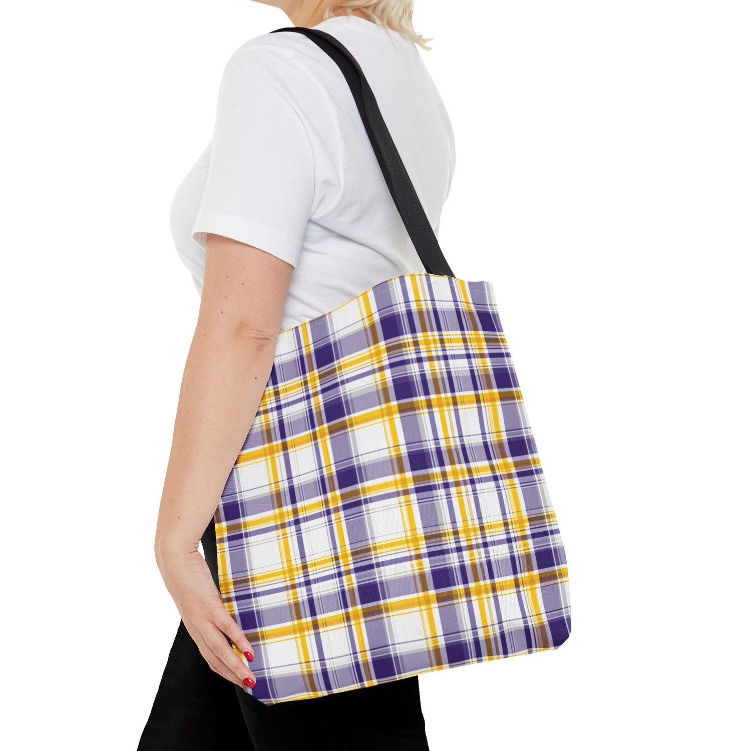 Person holding a plaid bag with purple, yellow, and white colors on a white background