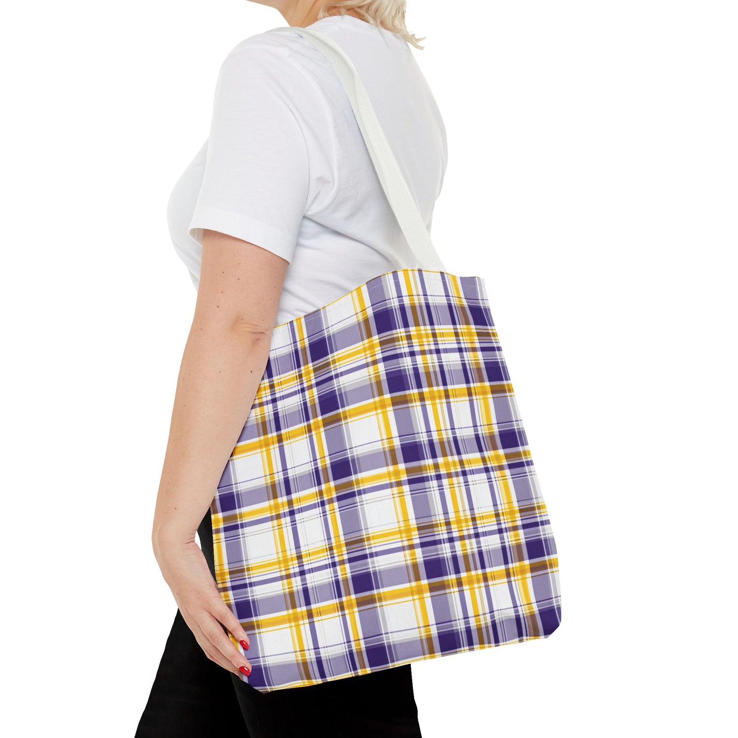 Person holding a plaid bag with purple, yellow, and white colors on a white background