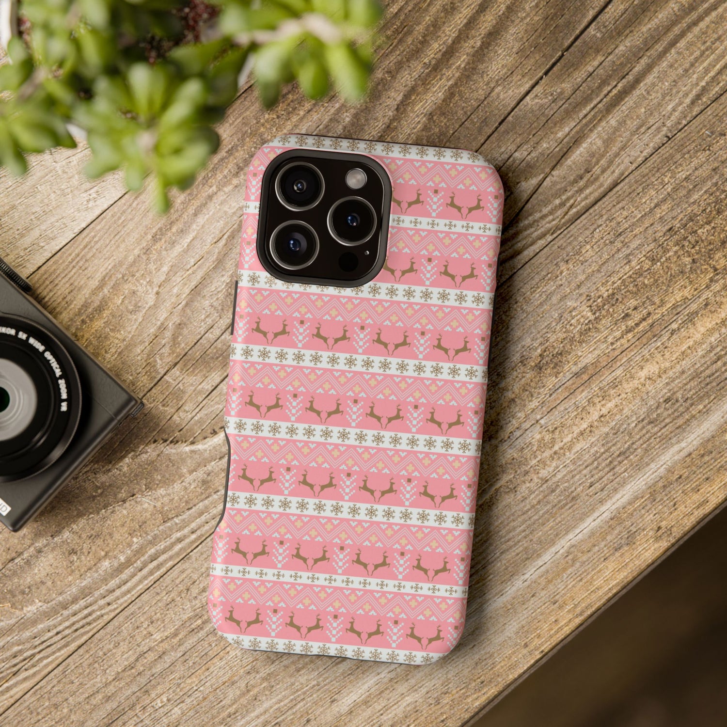 A pink Christmas-themed phone case with a pattern of deer antlers and stars, featuring a black removable TPU inner layer.