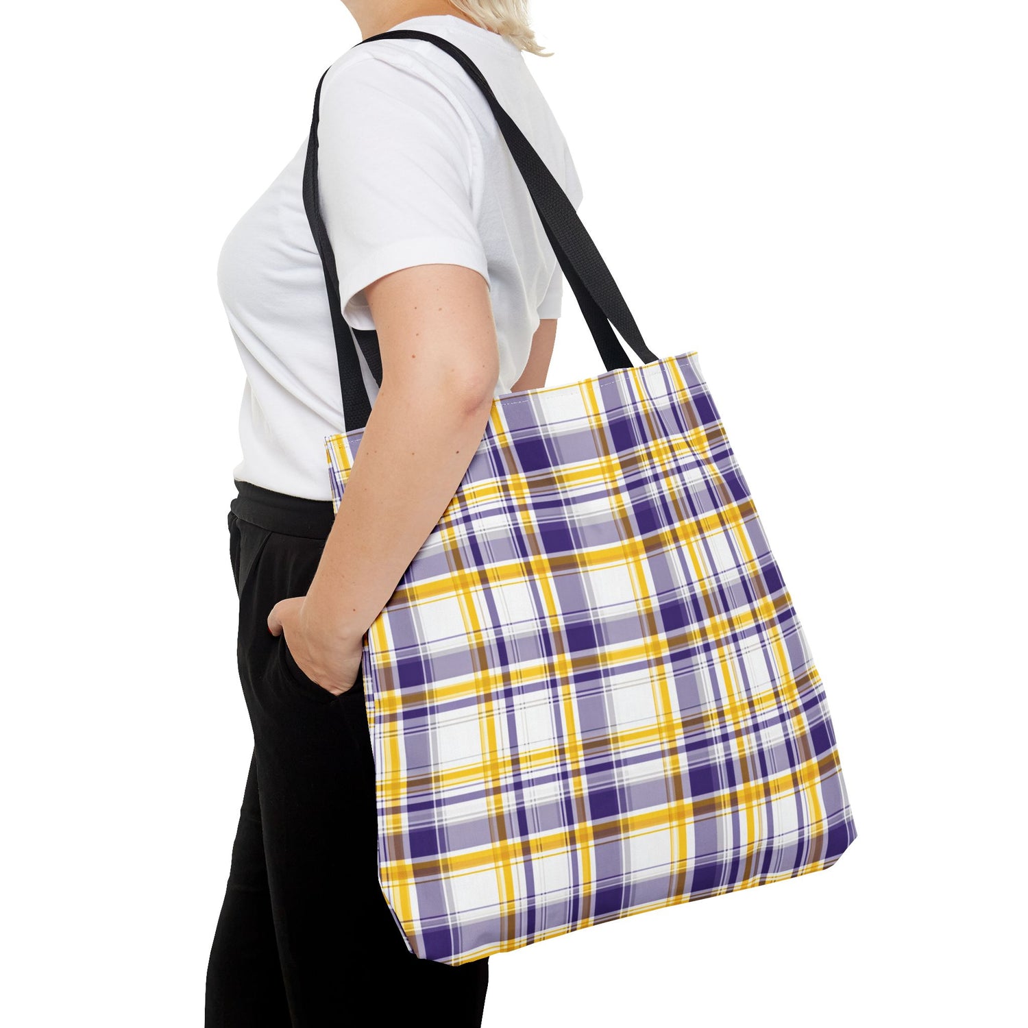 Person wearing a purple and yellow plaid tote bag on a white background