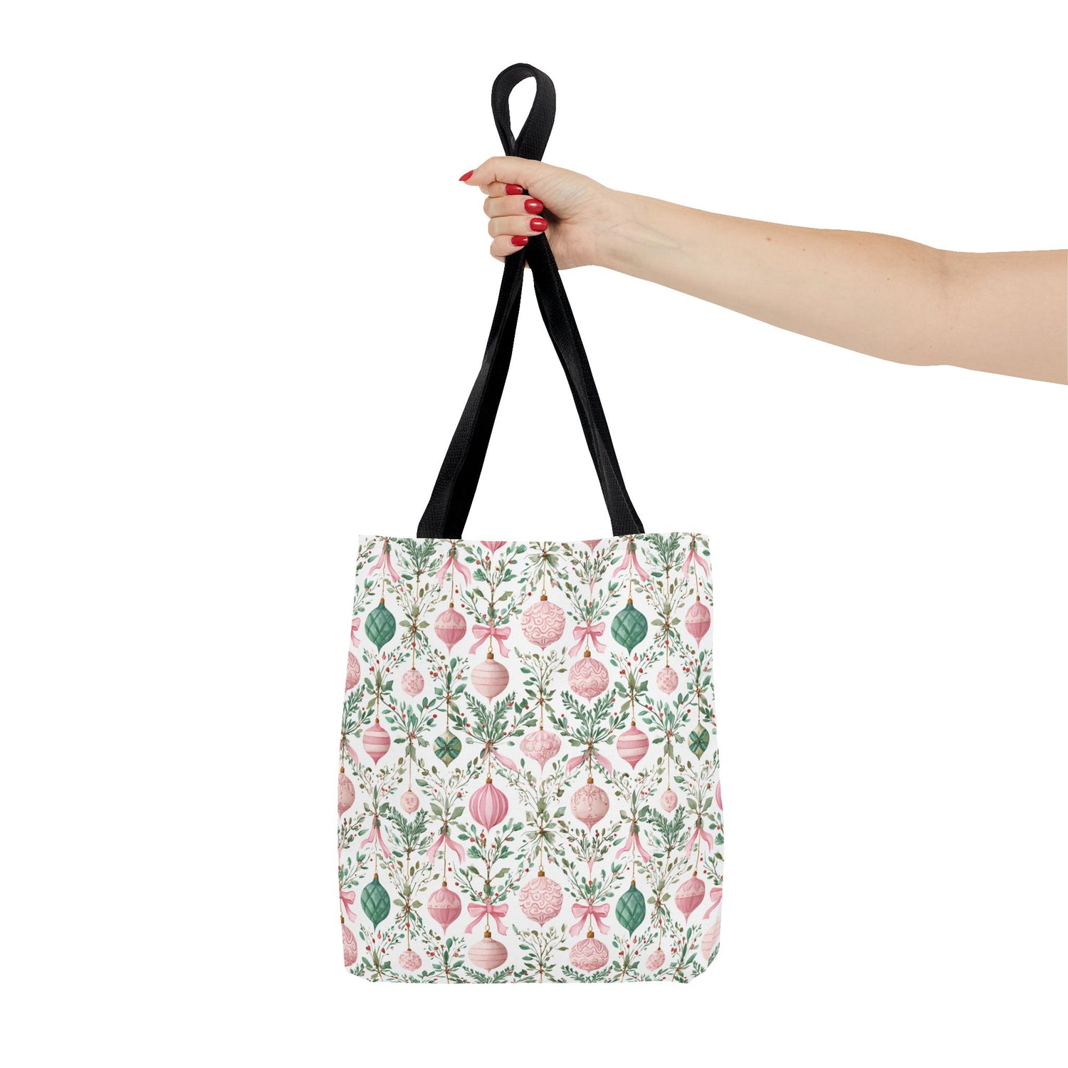 Tote bag with decorative pattern held by a hand on a white background