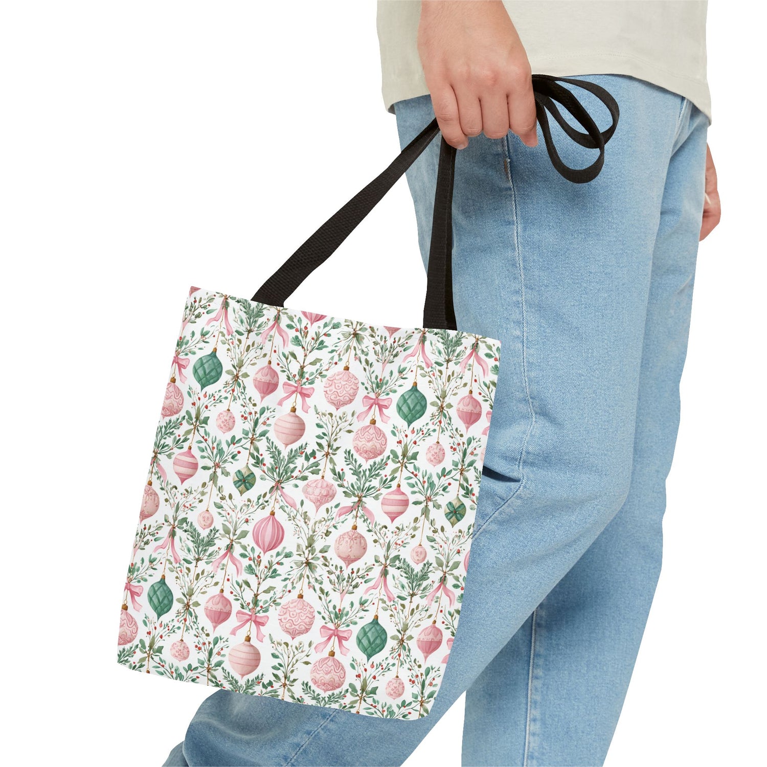 Tote bag with floral and Christmas ornament pattern held by a person wearing jeans.