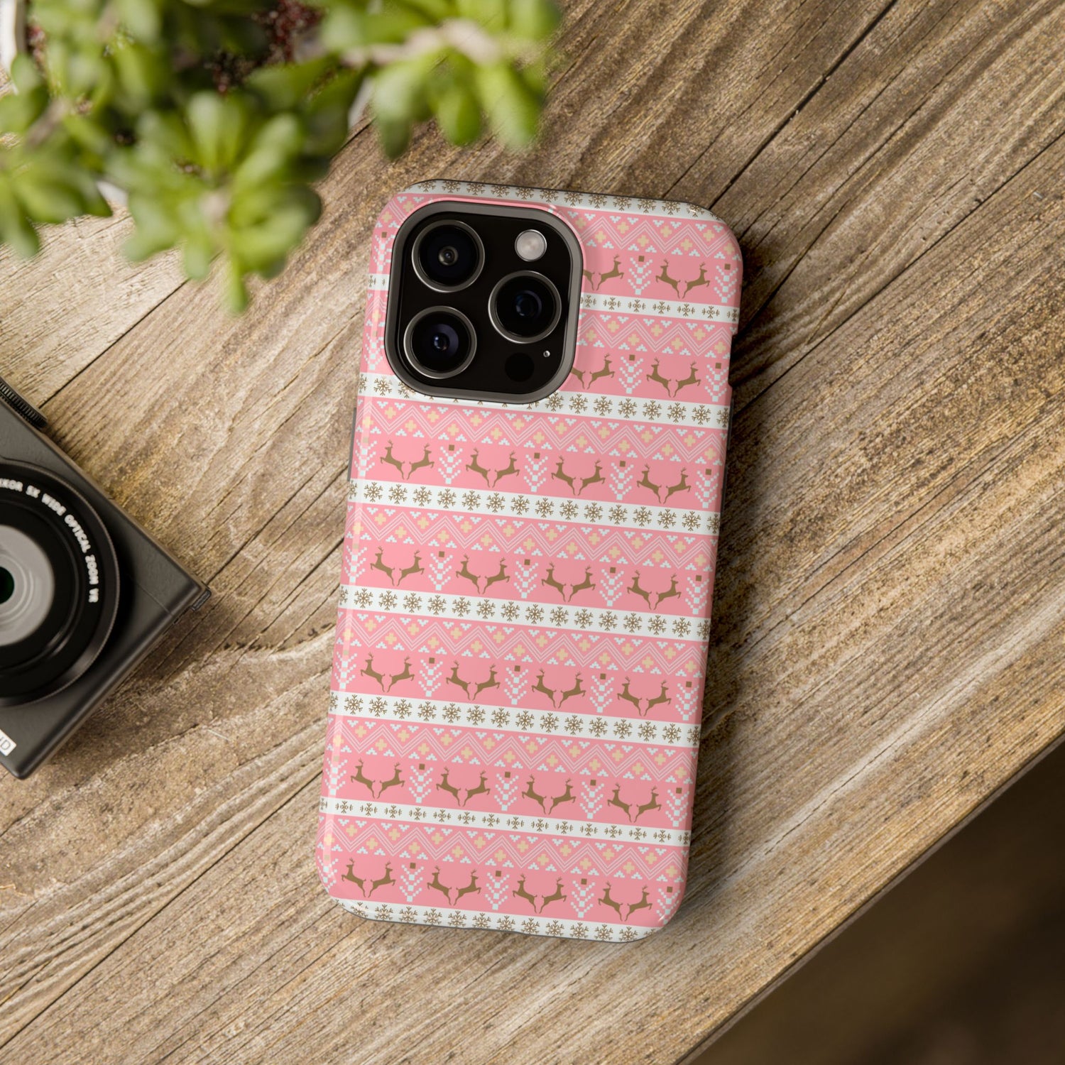 A pink Christmas-themed phone case with a pattern of deer antlers and stars, featuring a black removable TPU inner layer.
