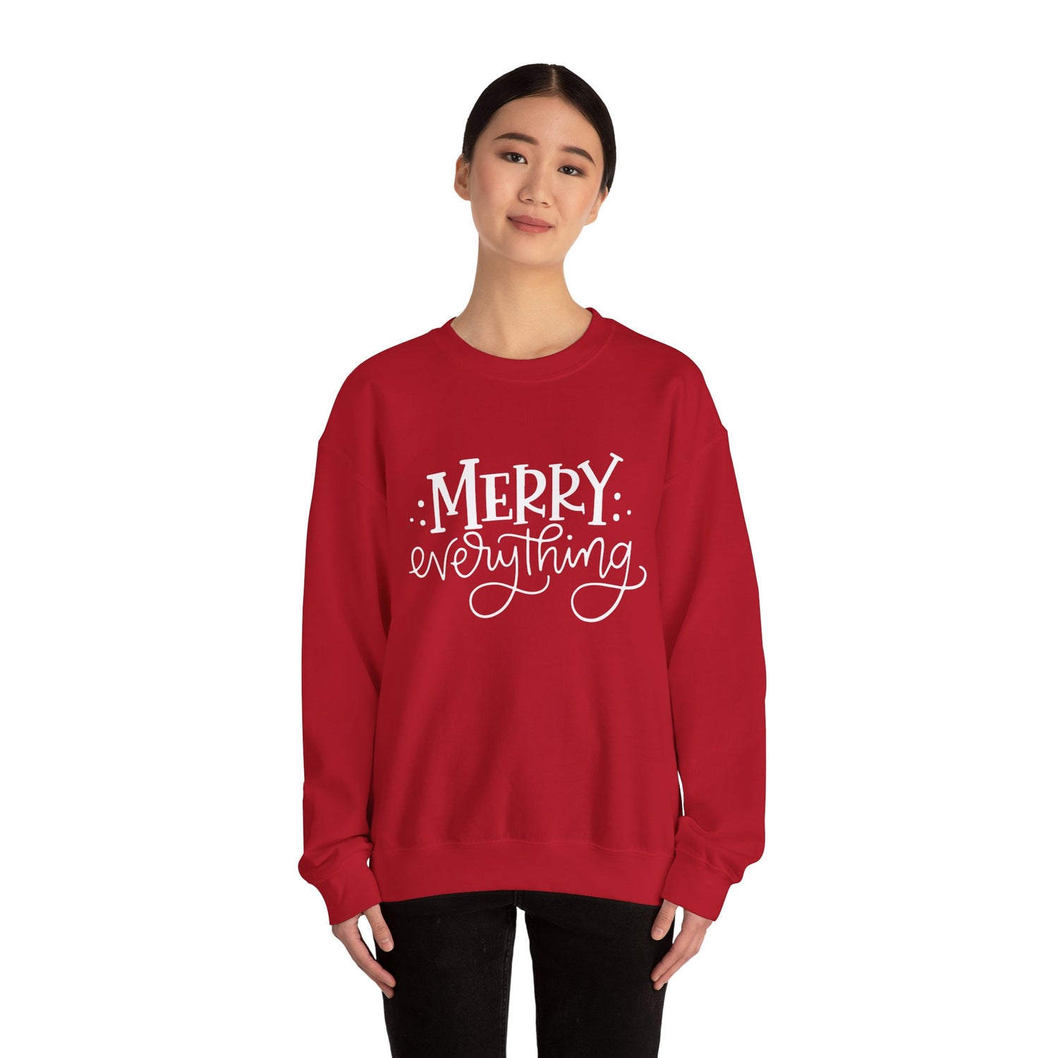 Red sweatshirt with 'Merry Everything' text worn by a person on a white background