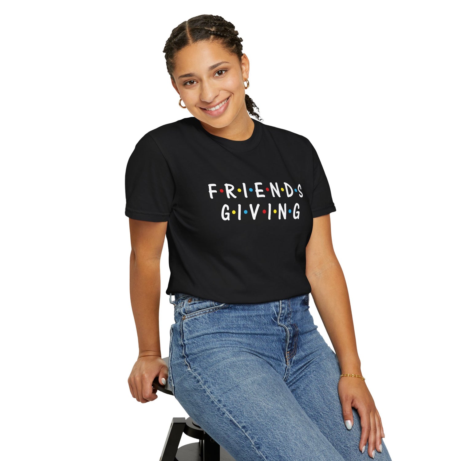 Person wearing a black 'FRIENDS GIVING' t-shirt on a white background
