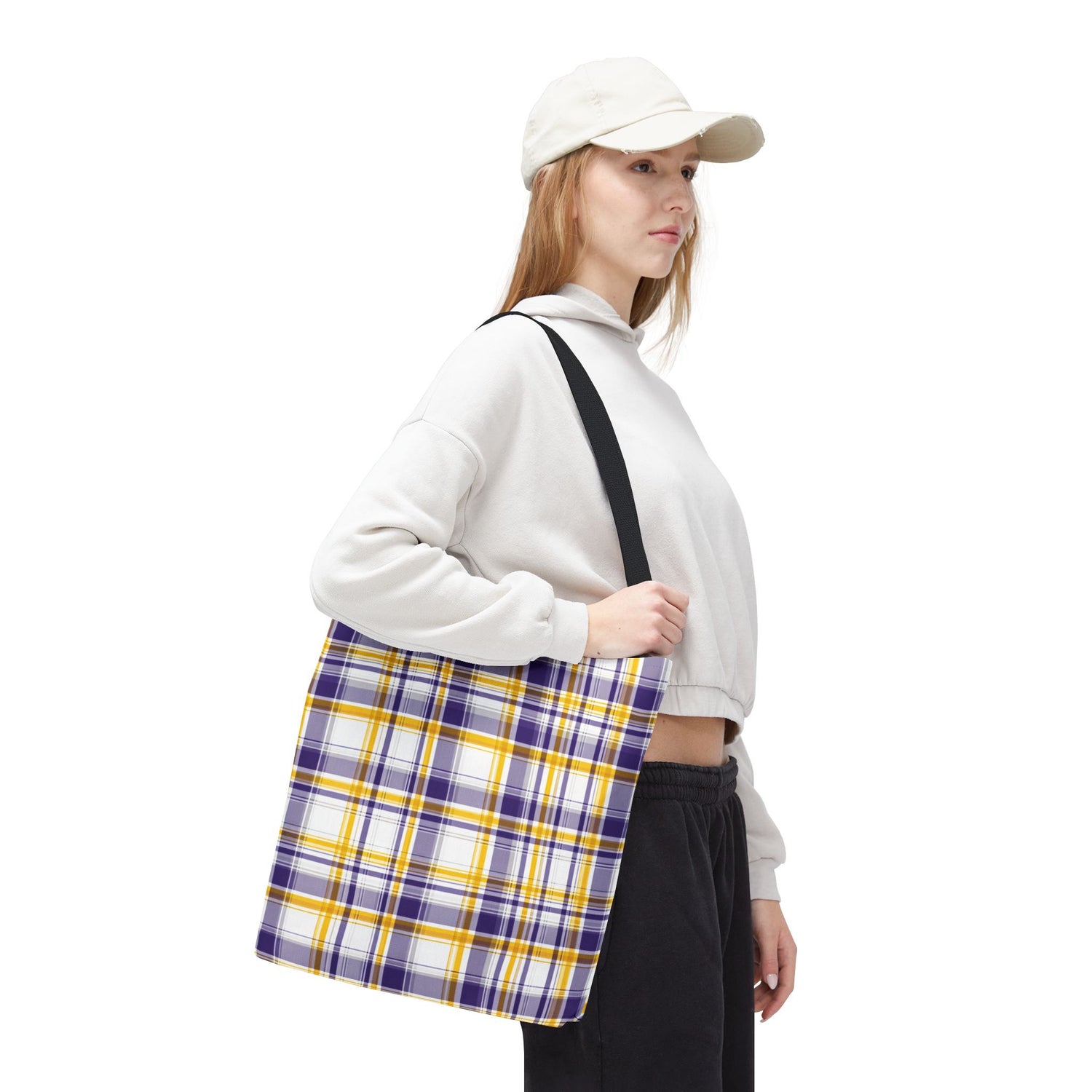 Person holding a plaid bag with a white background