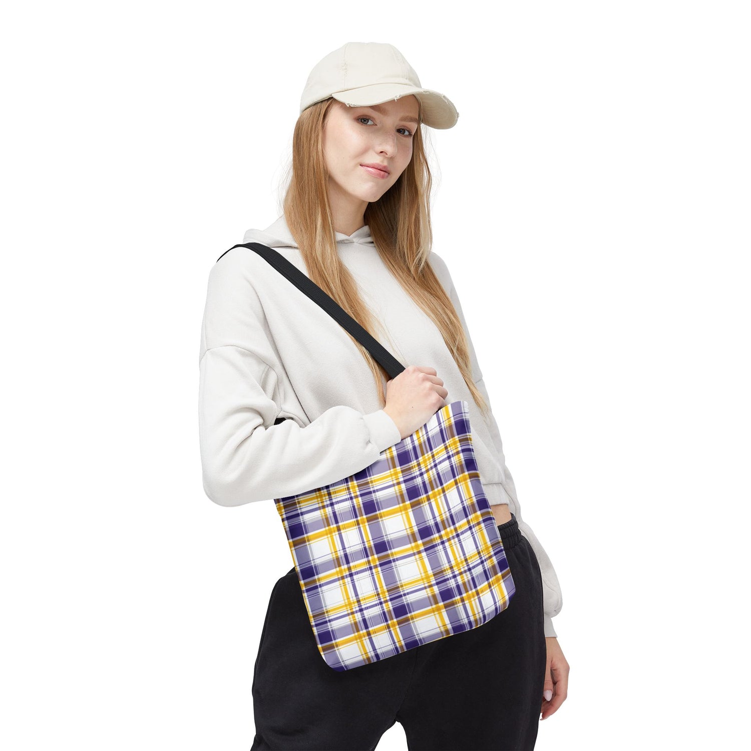 Person holding a plaid bag on a white background