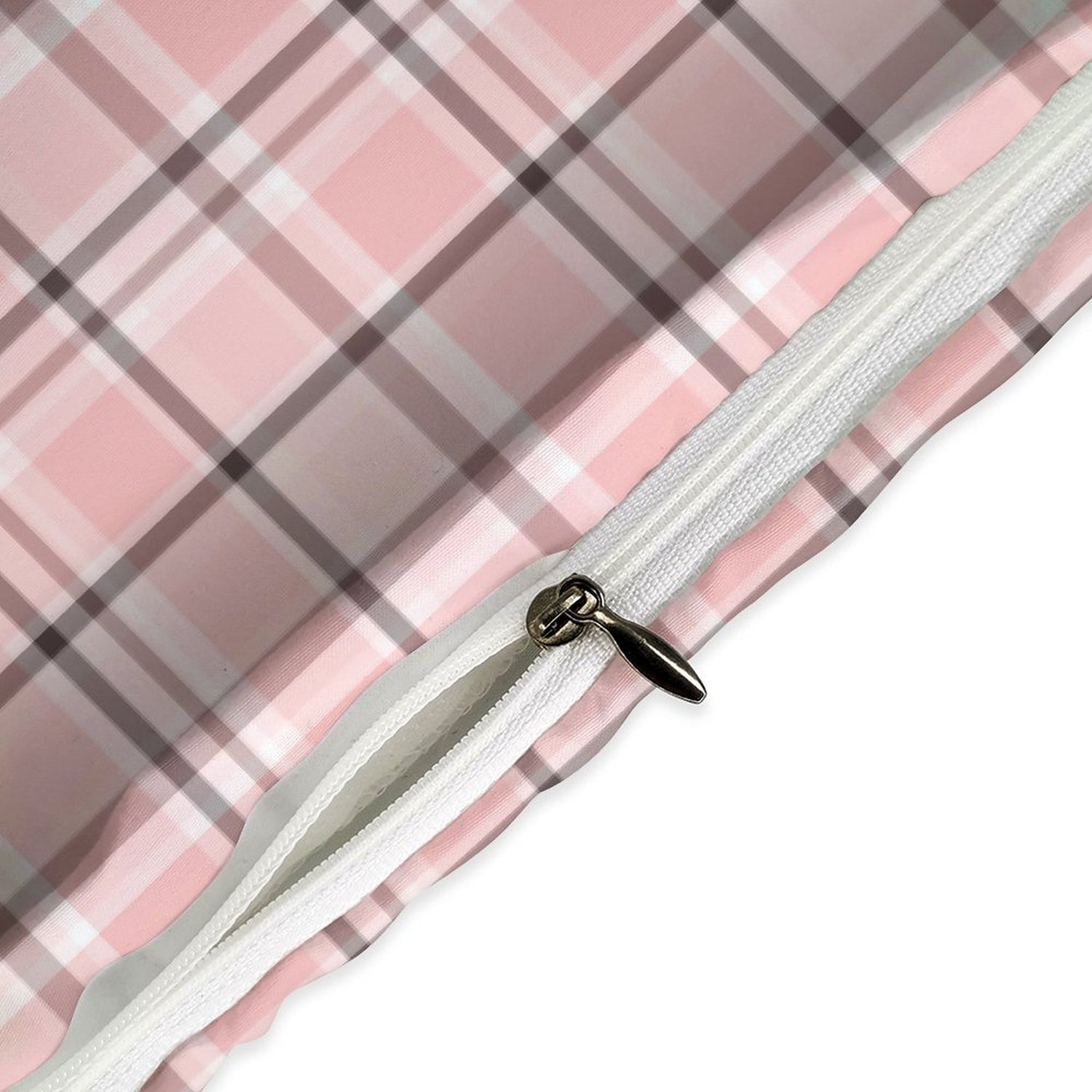 Close-up of a pink and gray plaid fabric with a white zipper.