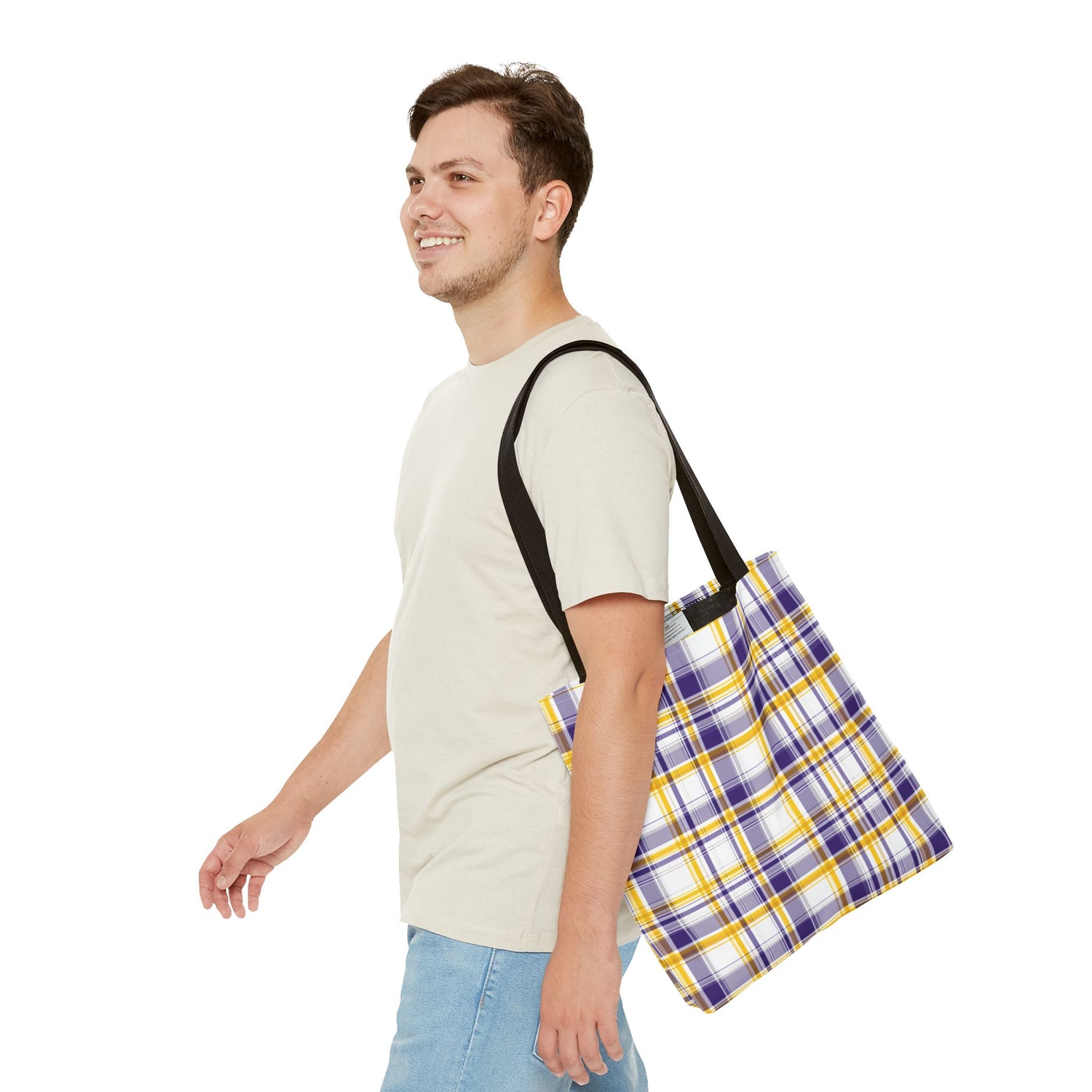 Man carrying a plaid tote bag on a white background