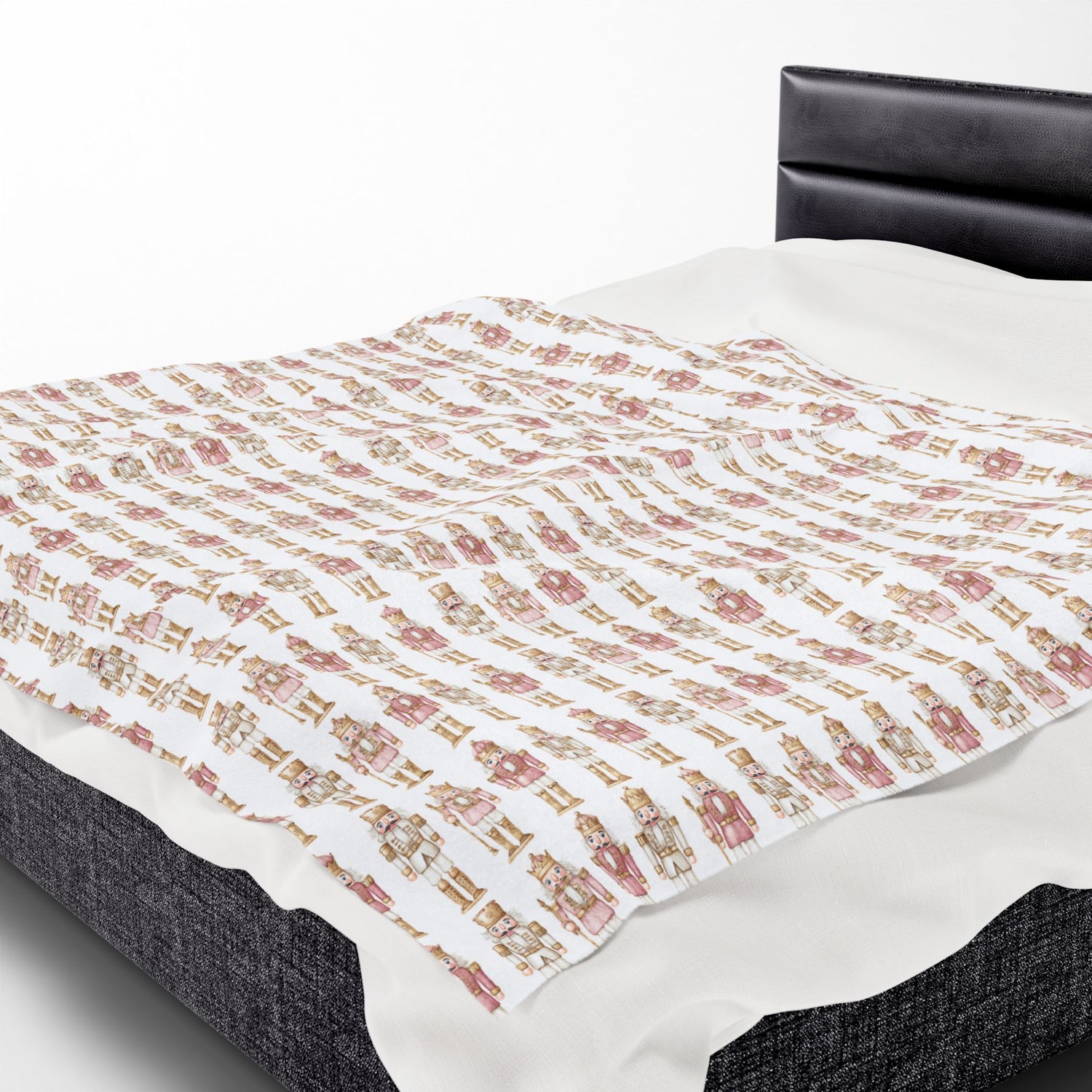 Floral-patterned quilt on a bed with a white background