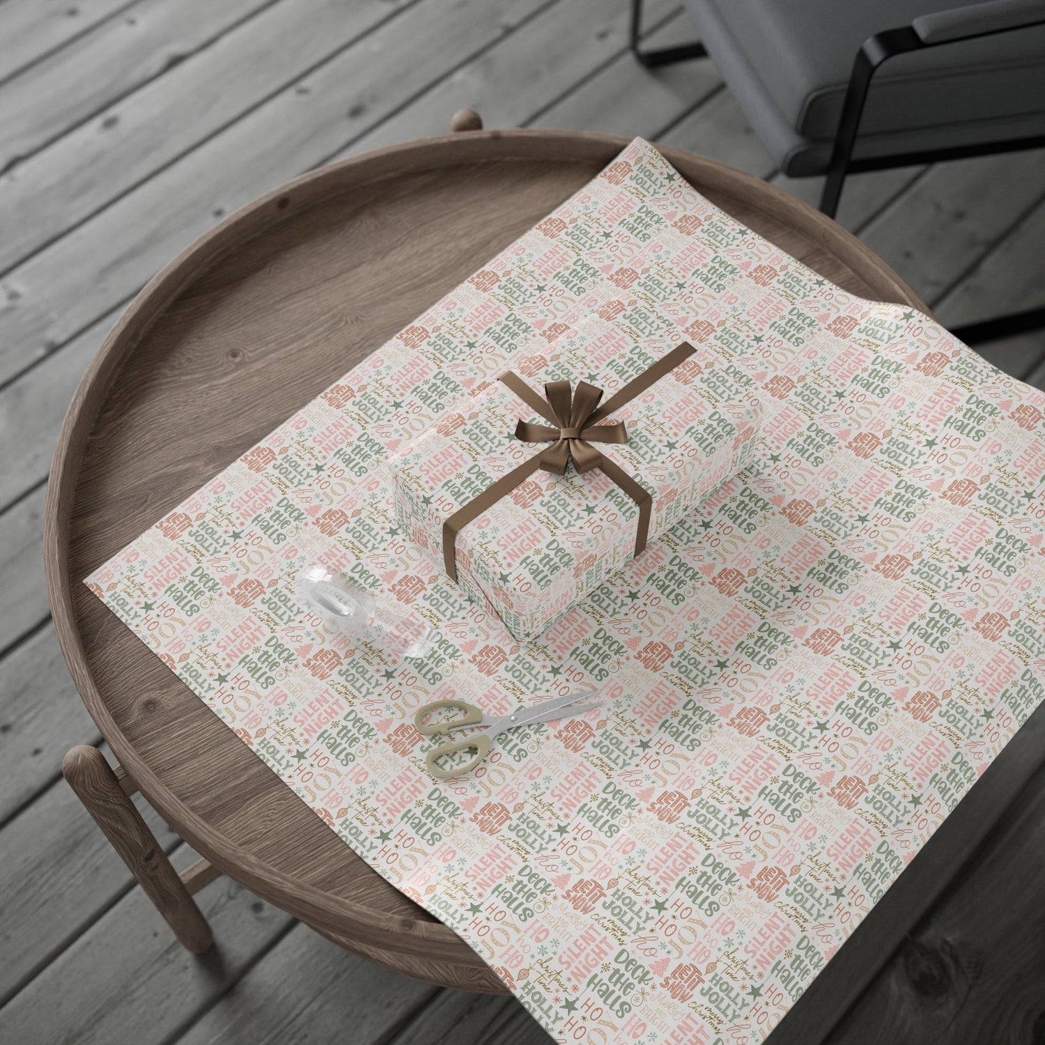Gift box with a bow on a patterned tablecloth on a wooden surface