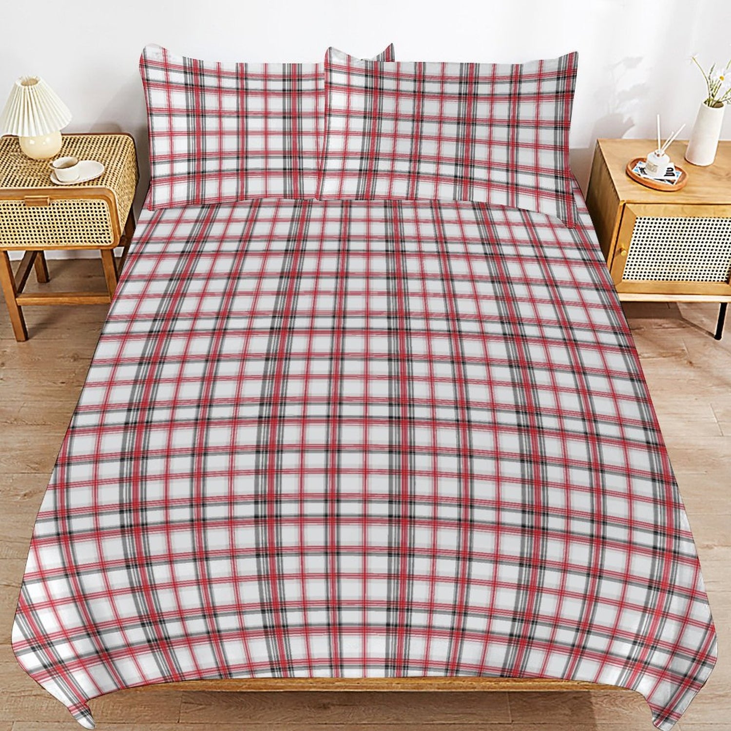 Red and white plaid bedspread on a bed with matching pillows in a bedroom setting.