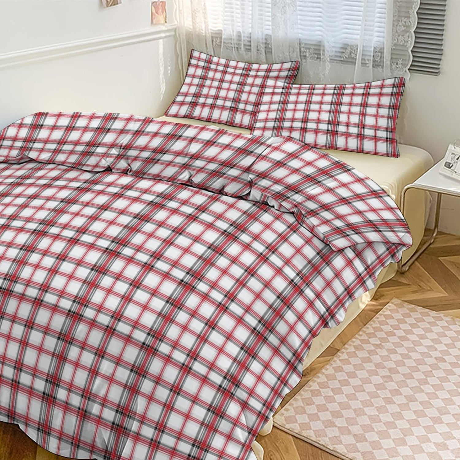 Red and white checkered duvet set on a bed in a bedroom.